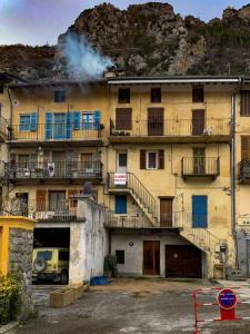 an old building with smoke coming out of it at Appartement cocooning pour un séjours à Tende in Tende