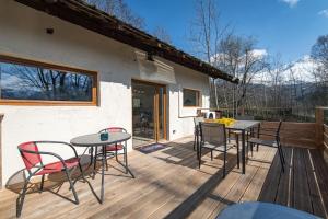 a patio with a table and chairs on a deck at albiez-hoterement 