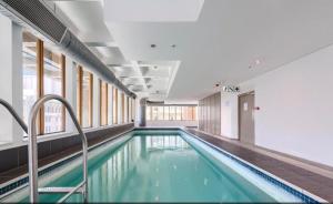 a swimming pool in a building at #2004 Cartwright - Glimmer Shimmer in Cape Town