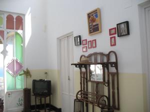 a room with a door and a tv and a window at Pension El Torreon in Mojácar