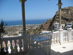 a balcony with a table and a view of the ocean at Pension El Torreon in Mojácar