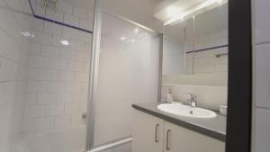 a bathroom with a sink and a shower at Air Appartement in Zaventem