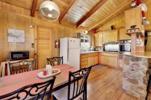 a kitchen and dining room with a table and chairs at Marin Getaway #2013 by Big Bear Vacations in Big Bear Lake +8 photos