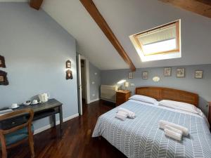 a bedroom with a bed with a desk and a window at The Secret Garden Relais in Piano di Sorrento