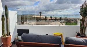 a living room with a couch and a large window at Infante Guesthouse in Lagos