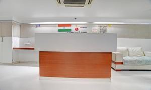 a reception desk in a room with a bed at Treebo Trend Cherry Tree in Indore