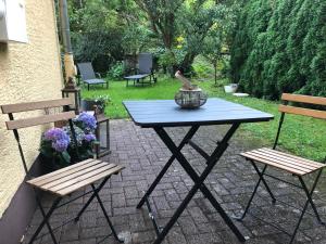 a picnic table with two chairs and a vase on it at Ferienwohnung miraBelle in Erbach