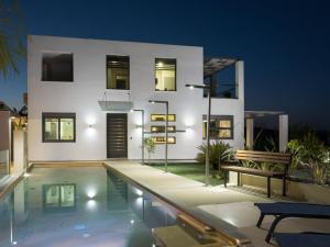 a house with a swimming pool in front of it at Villa Alyona in Skinés
