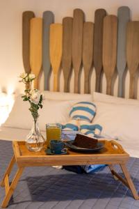 a coffee table with a tray of food on a bed at Suitetti Camere&Relax in San Nicola Arcella