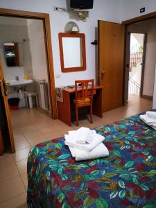 A bed or beds in a room at Osteria dei Locandieri