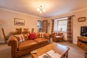 a living room with a couch and a table at Fisherman's Cottage in Newbiggin-by-the-Sea