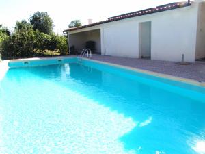 a large blue swimming pool next to a building at Hotel Rural Villa Julia in Vila Flor