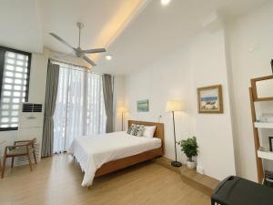 a bedroom with a bed and a ceiling fan at Daisy House in Tuy Hoa