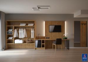 a living room with a desk and a television at Threeland Hotel in P&eacute;tange