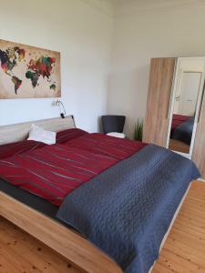 a bedroom with a large bed with a red blanket at Ferienwohnung Gartenblick in Bernkastel-Kues