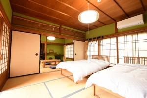 Postel nebo postele na pokoji v ubytování 高野山 宿坊 熊谷寺 -Koyasan Shukubo Kumagaiji-