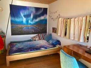 a bedroom with a bed and a desk and a painting at Poolvilla in Caputh +15 photos
