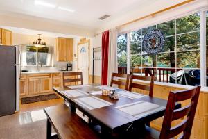 a kitchen and dining room with a table and a refrigerator at Montana Cabin - 1938 by Big Bear Vacations in Big Bear City +11 photos