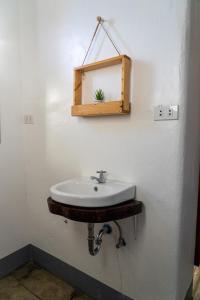 a bathroom with a sink and a mirror on the wall at MOMO Hostel in Moalboal