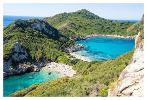 an aerial view of a beach on a mountain at Private Villa's in NW Corfu with Pool in Kavvadádes