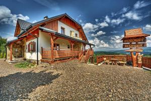 a large wooden house with a sign in front of it at Beskidnik in Polańczyk