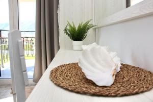 a table with a white bowl on top of it at Sunny Apt at Regina Apartments in Zakynthos Town