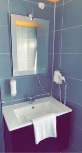 W łazience znajduje się umywalka z lustrem i telefon. w obiekcie Hotel-Restaurant Kastel w mieście Bernkastel-Kues