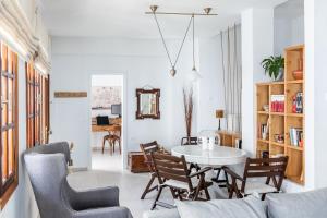 a living room with a table and chairs at Sokaki Home - Central Skopelos Town Hideaway in Skopelos Town