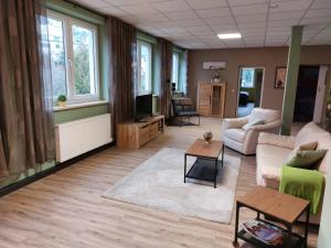 a living room with a couch and a tv at Zur alten Werkstatt in Schwarzenberg/Erzgebirge