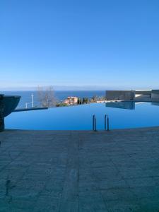 a swimming pool with a view of the water at Apartment in Taormina in Taormina