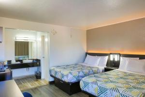 a hotel room with two beds and a mirror at Motel 6-Sacramento, CA - Central in Sacramento