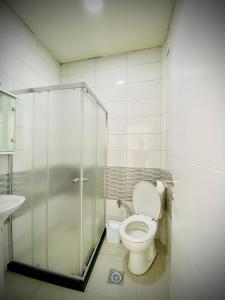 a bathroom with a toilet and a glass shower at Hotel Perla in Prizren