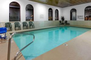 a large swimming pool with chairs in a building at Sandia inn & suites in Albuquerque