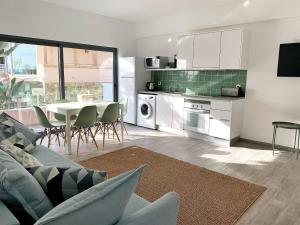 a kitchen and living room with a couch and a table at DIANA BEACH HOUSE in Albufeira