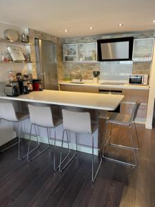 a kitchen with a island with chairs and a counter top at Appartement Loft Cannes in Cannes