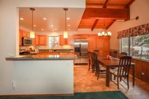 a kitchen with a table and chairs and a counter at La Cerena Getaway #1960 by Big Bear Vacations in Big Bear Lake