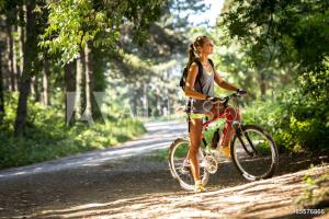 a woman riding a bike on a dirt road at Le Collet Vert in Wamin