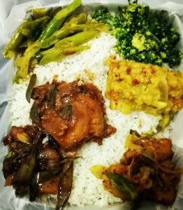 a plate of rice with meat and vegetables on it at heritage thambapanni in Anuradhapura