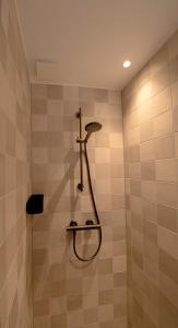 a shower with a shower head in a bathroom at The Lake Inn in Nieuwkoop