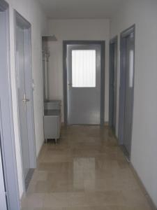 an empty hallway with a door and a window at Apartment Ivan - beautiful sea view in Splitska