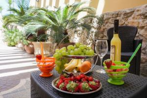 メレンドゥーニョにあるGuesthouse da Filibertoの- フルーツとワイン1本を用意したテーブル