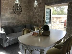 a living room with a white table and a couch at Stone house Chiara Seaview in Funtana