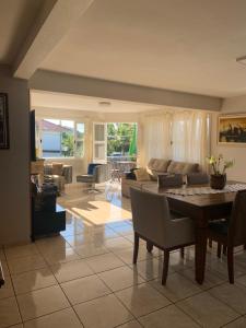 a living room with a table and a couch at Recanto da Sol in Florianópolis