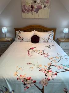 a bedroom with a bed with flowers on it at River cottage in Fort William