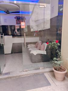 a display window of a store with a couch and flowers at Vidya Guest House in Katra