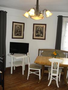 ein Esszimmer mit einem Tisch und einem Schreibtisch mit einem Computer in der Unterkunft Appartement 25 qm mit Bad an der Mosel - Nähe Koblenz in Dieblich