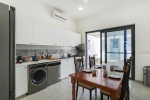 a kitchen with a wooden table and a dining room at To Hani - Kamara Maisonette in Nicosia +14 photos