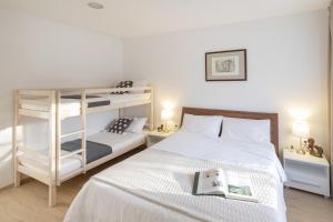 a bedroom with two bunk beds and a book at Apartments Mario in Pula