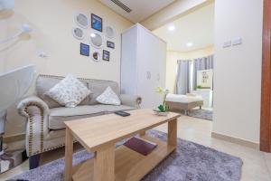 a living room with a couch and a table at Budget Cozy Studio in Dubai Gate 2 JLT - ELA in Dubai