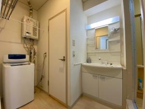 a small bathroom with a sink and a mirror at Close to Sapporo station & Hokkaido University Hokusei 6F in Sapporo